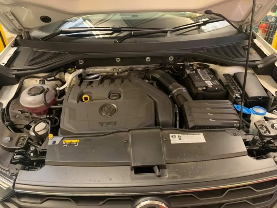 A vehicle engine bay being checked over in the workshop
